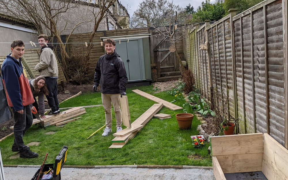 Harry's friends in the process of carrying out a home improvement project in their garden